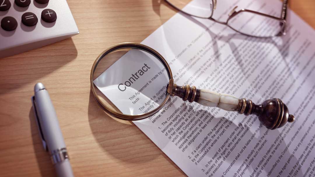 magnifying glass on a legal contract