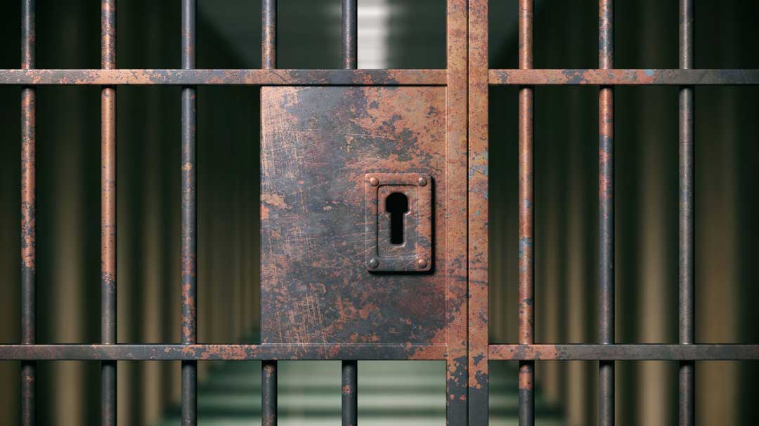 prison interior locked rusty door closeup