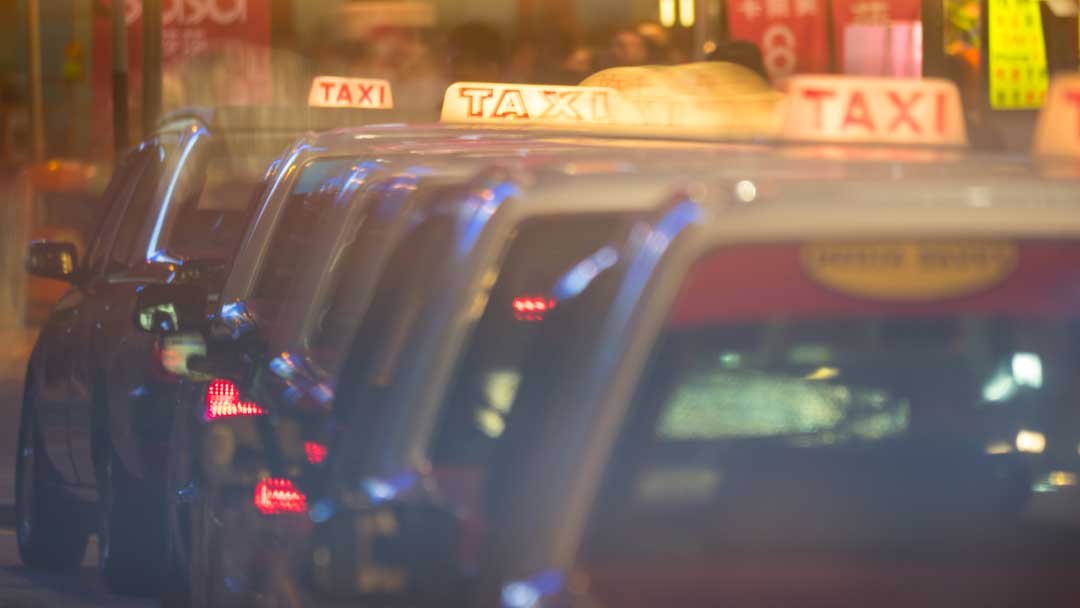 row of taxi cars in night street